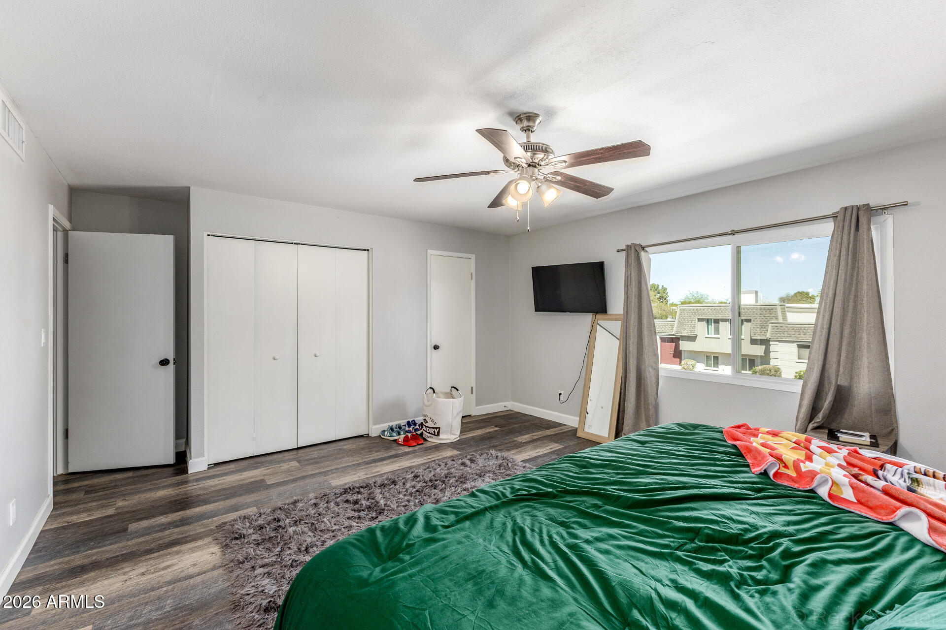 4923 North Granite Reef Road Scottsdale, AZ 85251 - Photo 16 of 28 a very nice looking bedroom with a bed and a flat screen tv