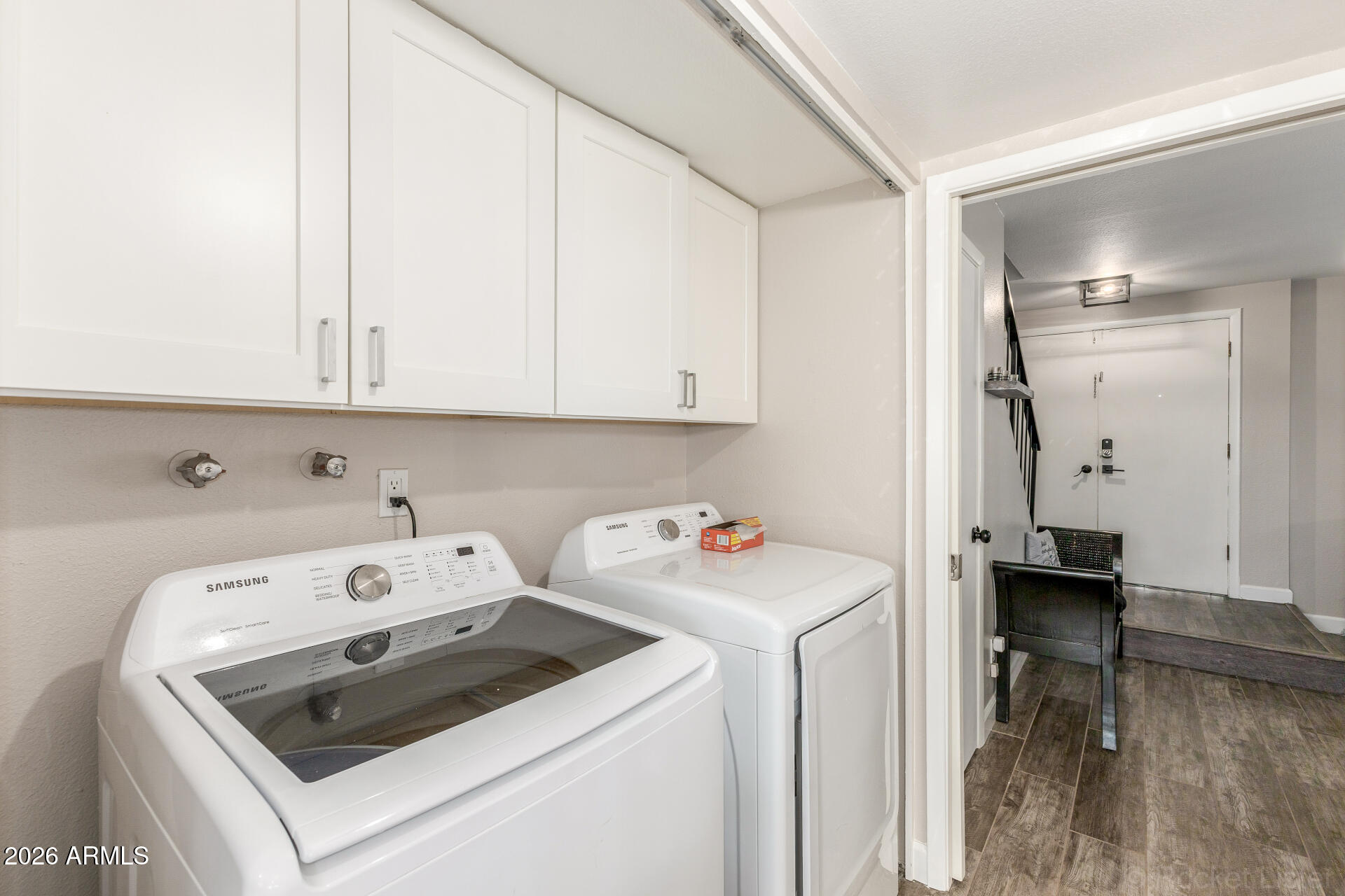 4923 North Granite Reef Road Scottsdale, AZ 85251 - Photo 19 of 28 a view of washer and dryer with kitchen in the background