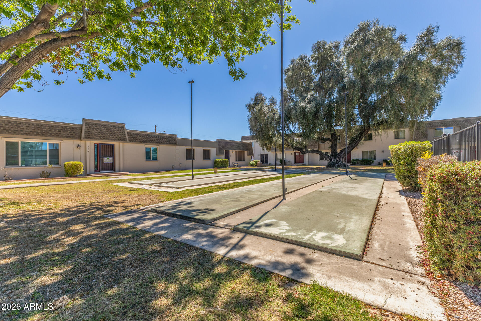 4923 North Granite Reef Road Scottsdale, AZ 85251 - Photo 27 of 28 a view of a swimming pool with a lawn chairs under an umbrella