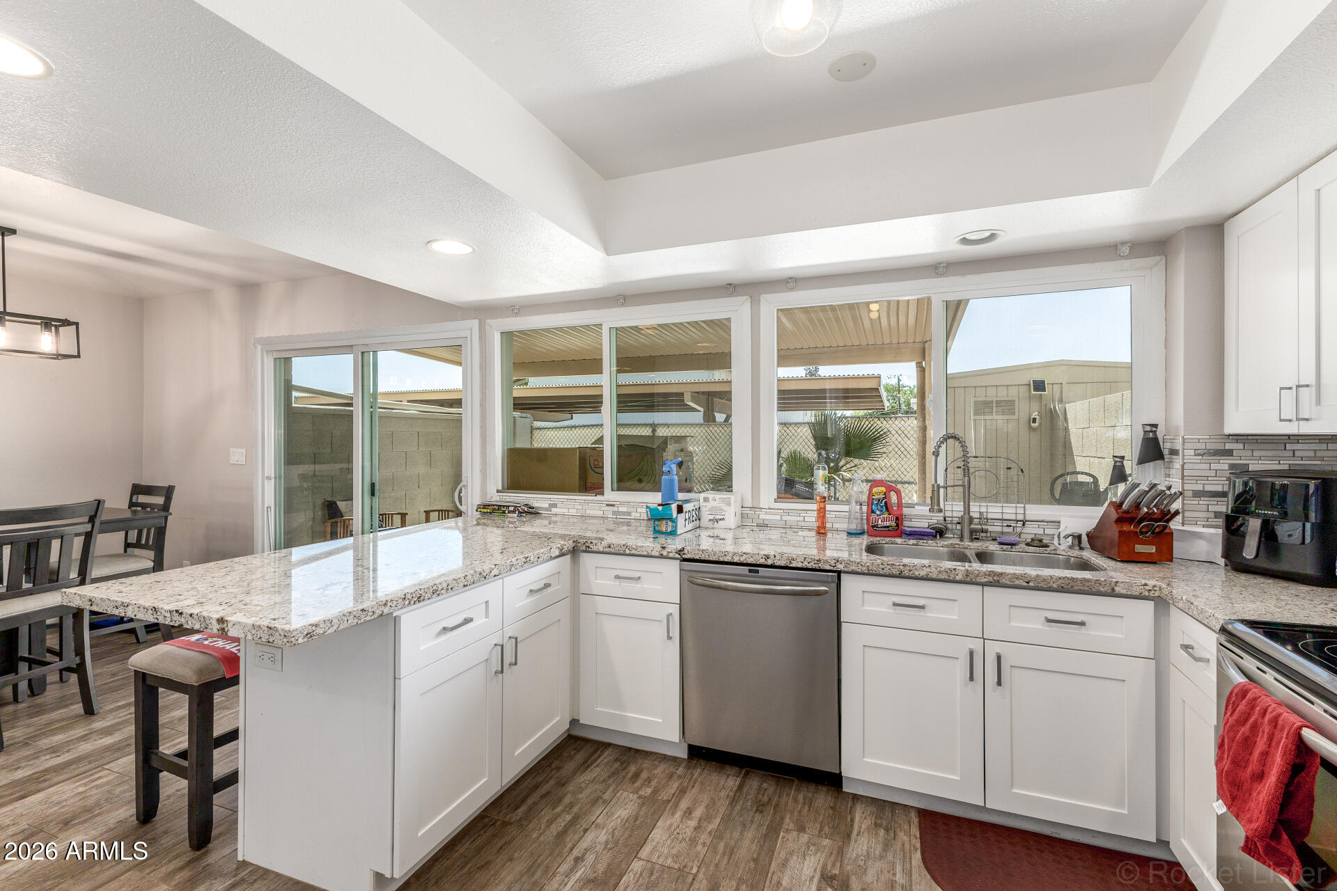 4923 North Granite Reef Road Scottsdale, AZ 85251 - Photo 9 of 28 a kitchen with a sink stove and cabinets