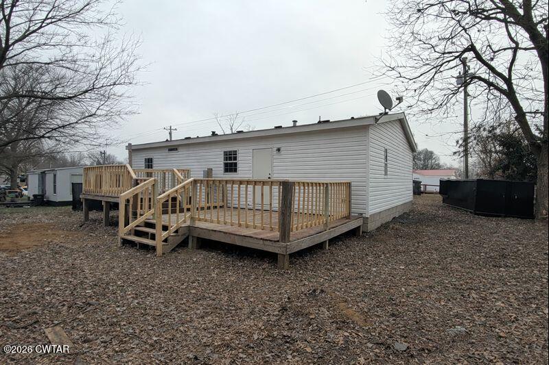 308 Broadway Street Obion, TN 38240 - Photo 13 of 16 a view of a house with a yard and deck