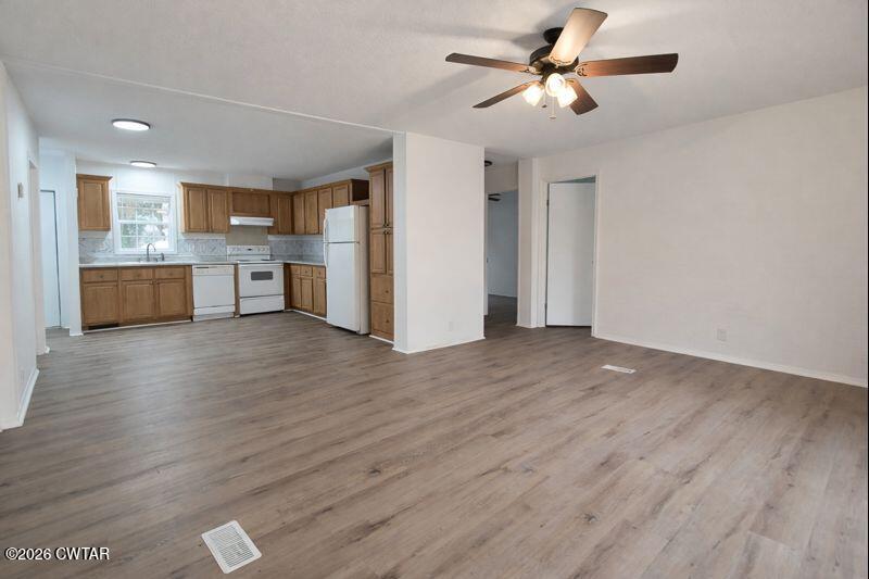 308 Broadway Street Obion, TN 38240 - Photo 3 of 16 a view of a kitchen and an empty room with wooden floor