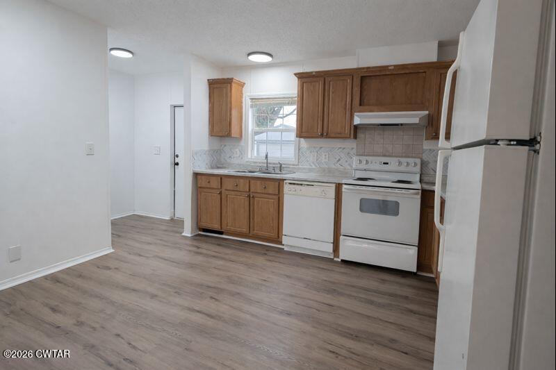 308 Broadway Street Obion, TN 38240 - Photo 6 of 16 a kitchen with stainless steel appliances granite countertop a sink and a stove top oven