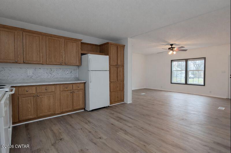 308 Broadway Street Obion, TN 38240 - Photo 7 of 16 an empty room with wooden floor cabinet and windows