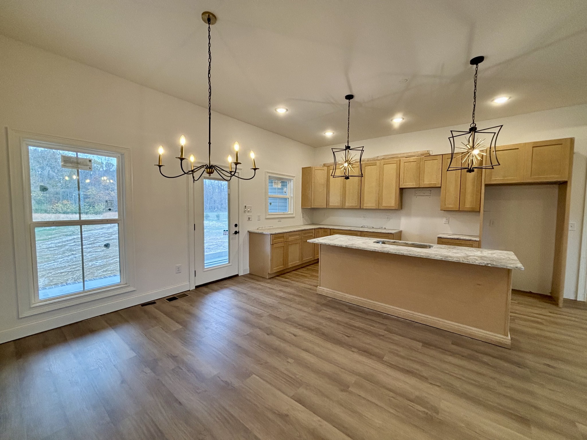 1798 Pocahontas Road Morrison, TN 37357 - Photo 8 of 24 a large kitchen with granite countertop a large center island a sink stainless steel appliances and cabinets