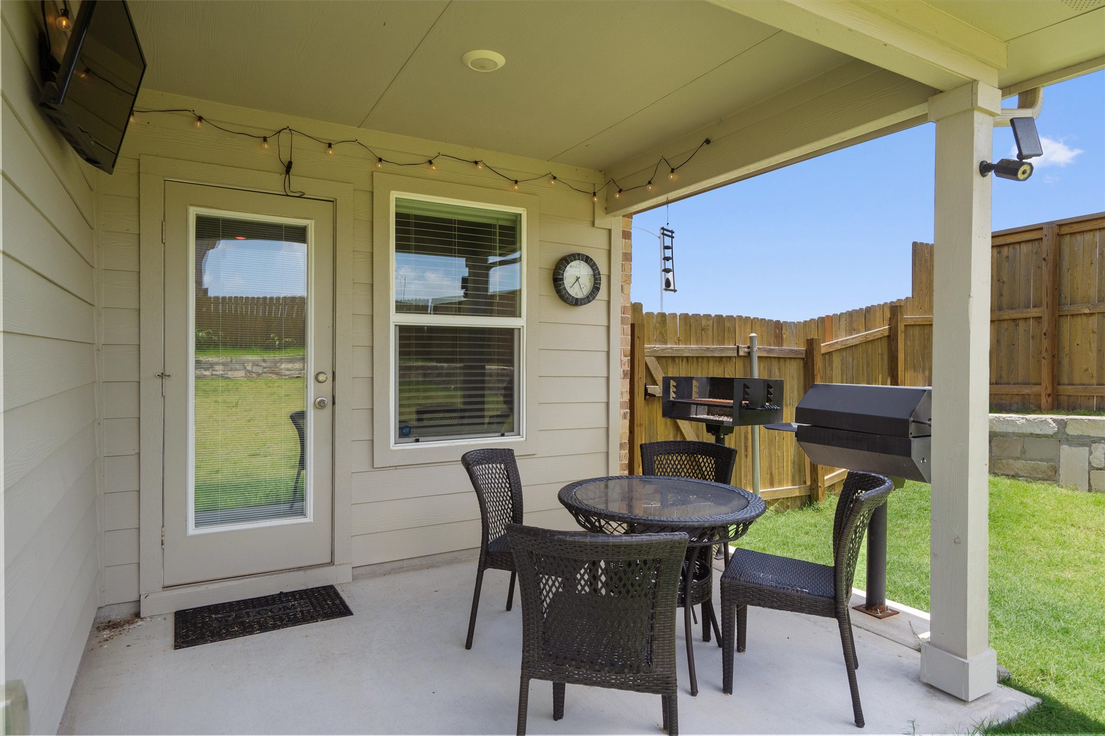 19525 Abigail Fillmore Road Manor, TX 78653 - Photo 28 of 38 Enjoy outdoor gatherings on this covered patio, complete with a grill and privacy fencing.
