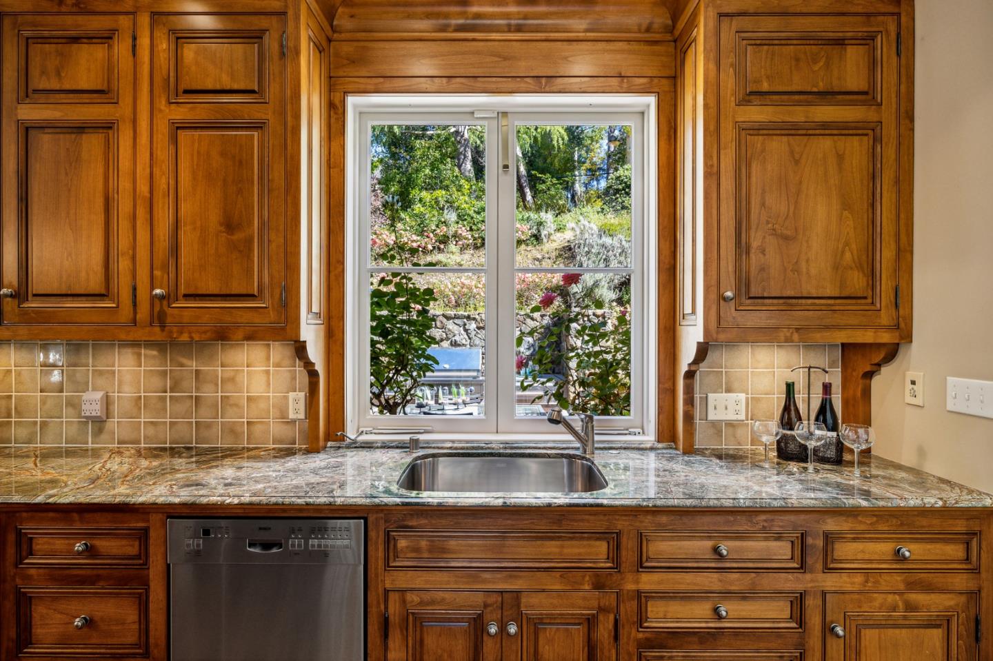 989 Hayne Road Hillsborough, CA 94010 - Photo 40 of 100 a kitchen with granite countertop a sink a window and cabinets