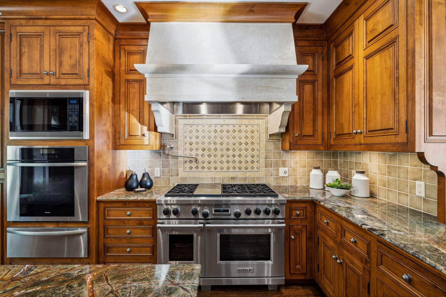 989 Hayne Road Hillsborough, CA 94010 - Photo 41 of 100 a kitchen with stainless steel appliances granite countertop a stove and a sink