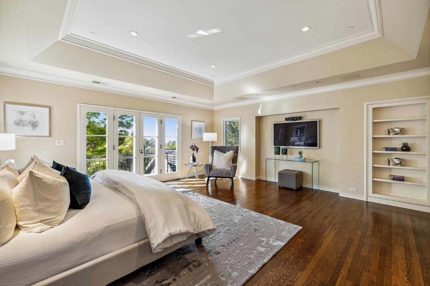 989 Hayne Road Hillsborough, CA 94010 - Photo 74 of 100 a large bedroom with a bed and a flat screen tv