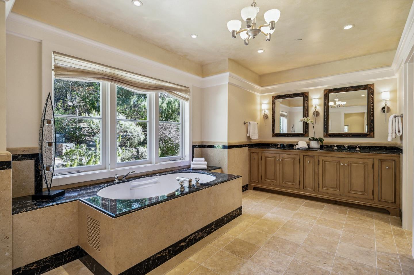 989 Hayne Road Hillsborough, CA 94010 - Photo 85 of 100 a spacious bathroom with a sink a large mirror and a bathtub