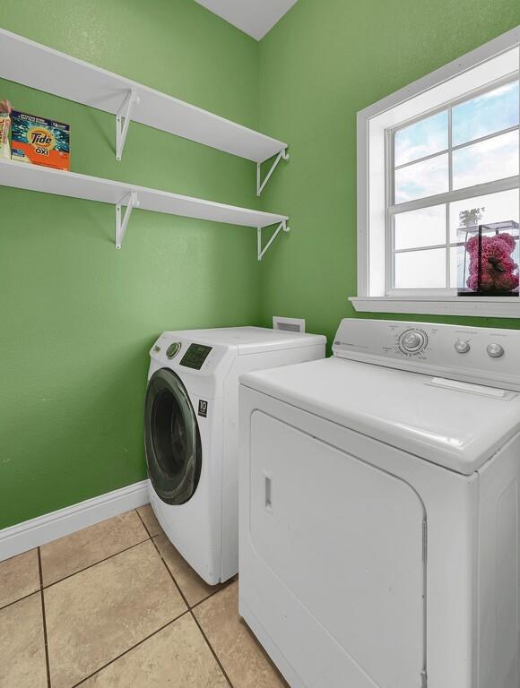 355 Highway 236 Moody, TX 76557 - Photo 25 of 36 Laundry room featuring washing machine and dryer, baseboards, and light tile patterned floors