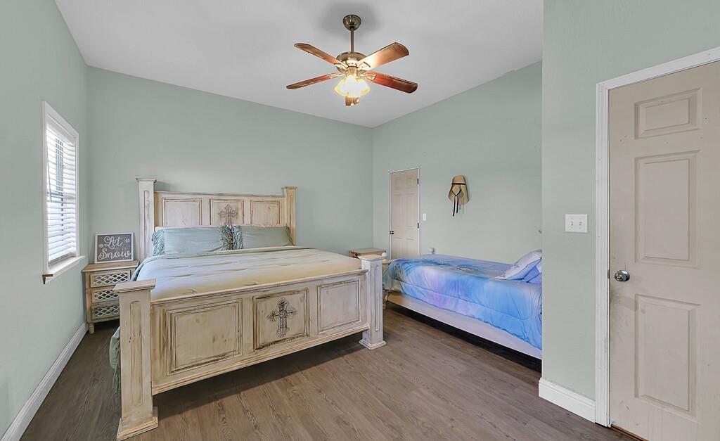 355 Highway 236 Moody, TX 76557 - Photo 27 of 36 Bedroom with baseboards, wood finished floors, and a ceiling fan