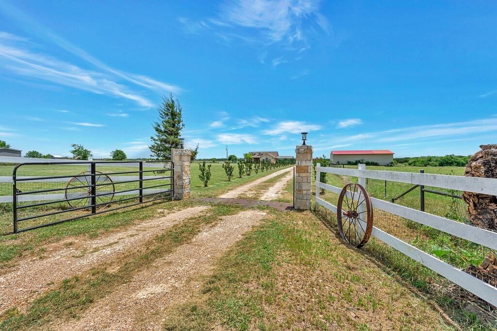 355 Highway 236 Moody, TX 76557 - Photo 3 of 36 View of dirt / gravel driveway with a view of countryside and a gated entry