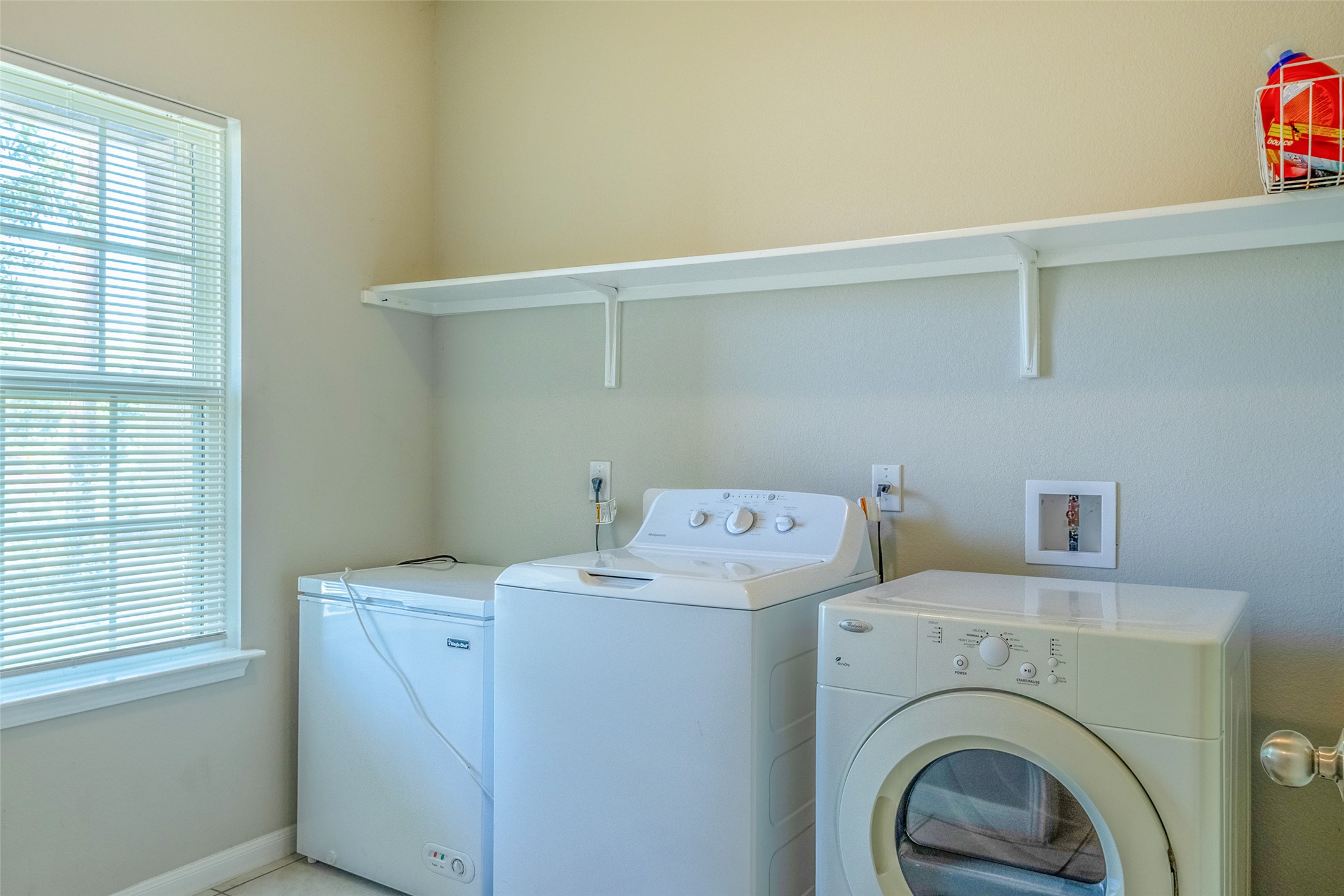 7225 Ranchito Drive Austin, TX 78744 - Photo 15 of 39 A well-organized laundry area offers a practical and bright space for household tasks.