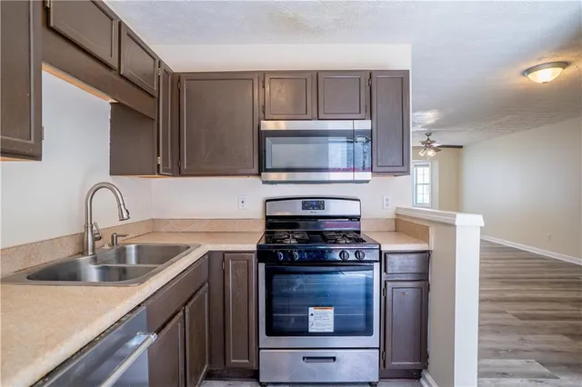 a kitchen with a stove and a microwave