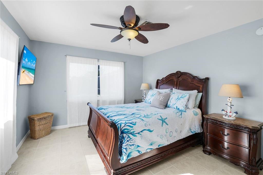 1237 Jamaica Road Marco Island, FL 34145 - Photo 13 of 26 a bedroom with a bed and a lamp