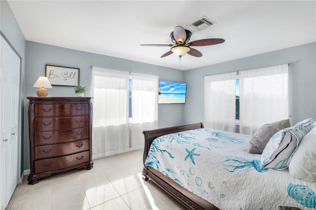 1237 Jamaica Road Marco Island, FL 34145 - Photo 14 of 26 a bedroom with a bed and a chandelier