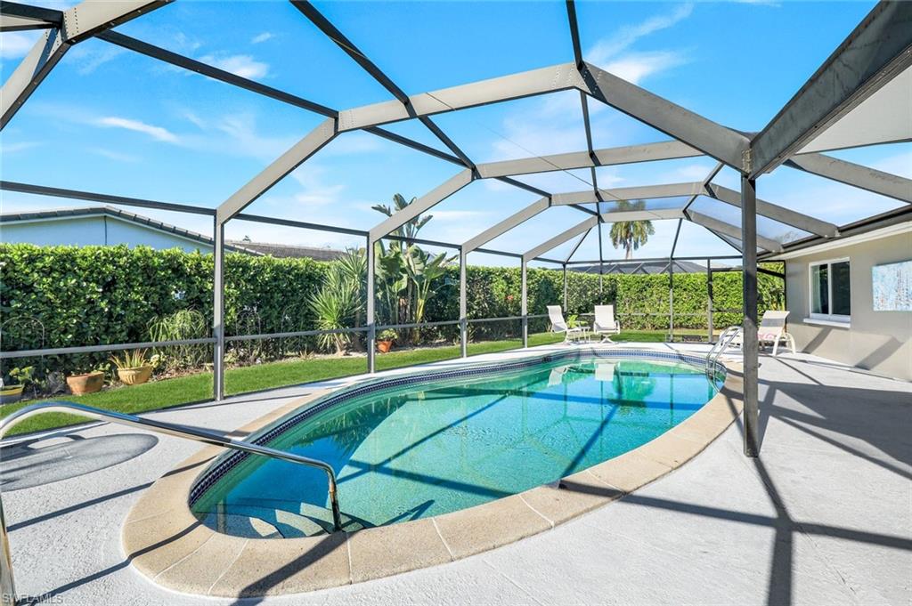 1237 Jamaica Road Marco Island, FL 34145 - Photo 19 of 26 a view of a swimming pool with a patio