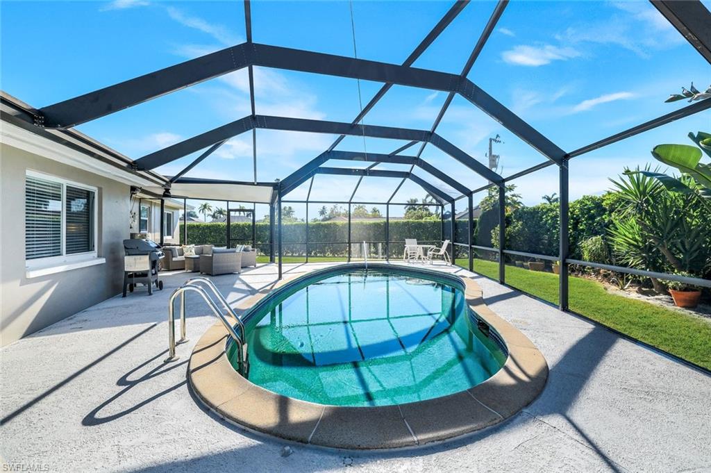 1237 Jamaica Road Marco Island, FL 34145 - Photo 20 of 26 a view of a swimming pool with a lounge chairs