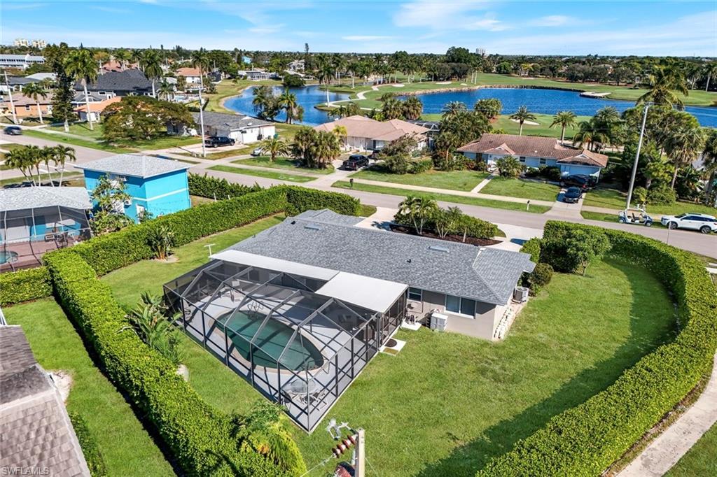 1237 Jamaica Road Marco Island, FL 34145 - Photo 2 of 26 an aerial view of a house with a garden and lake view