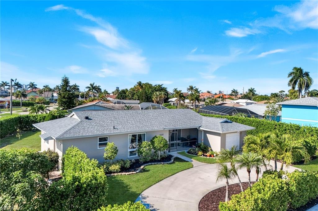 1237 Jamaica Road Marco Island, FL 34145 - Photo 22 of 26 a view of a house with a yard and potted plants