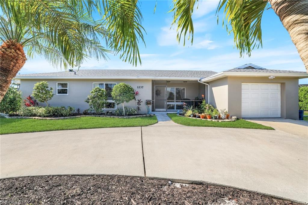 1237 Jamaica Road Marco Island, FL 34145 - Photo 3 of 26 a front view of house with yard and green space