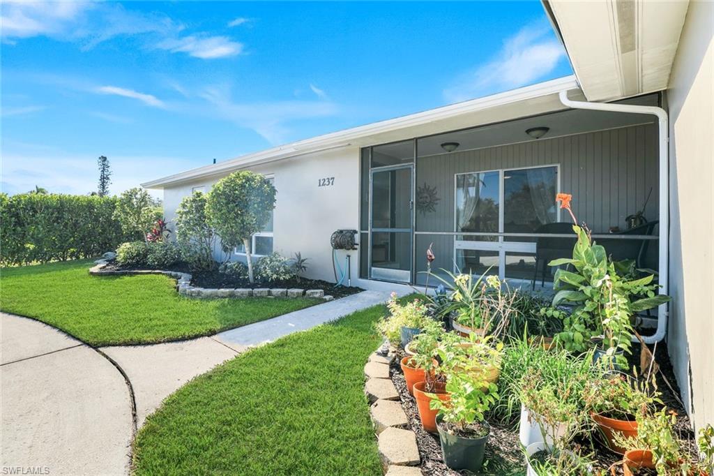 1237 Jamaica Road Marco Island, FL 34145 - Photo 4 of 26 a front view of a house with garden
