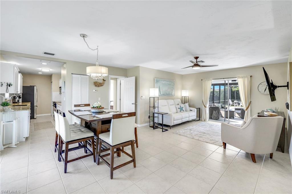 1237 Jamaica Road Marco Island, FL 34145 - Photo 6 of 26 a living room with furniture and a dining table with projector the kitchen