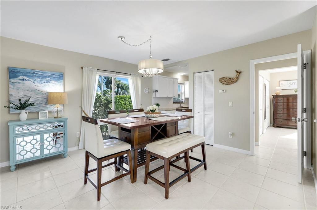 1237 Jamaica Road Marco Island, FL 34145 - Photo 8 of 26 a view of a dining room with furniture and a chandelier