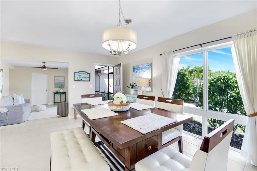 1237 Jamaica Road Marco Island, FL 34145 - Photo 9 of 26 a living room with patio furniture and a large window