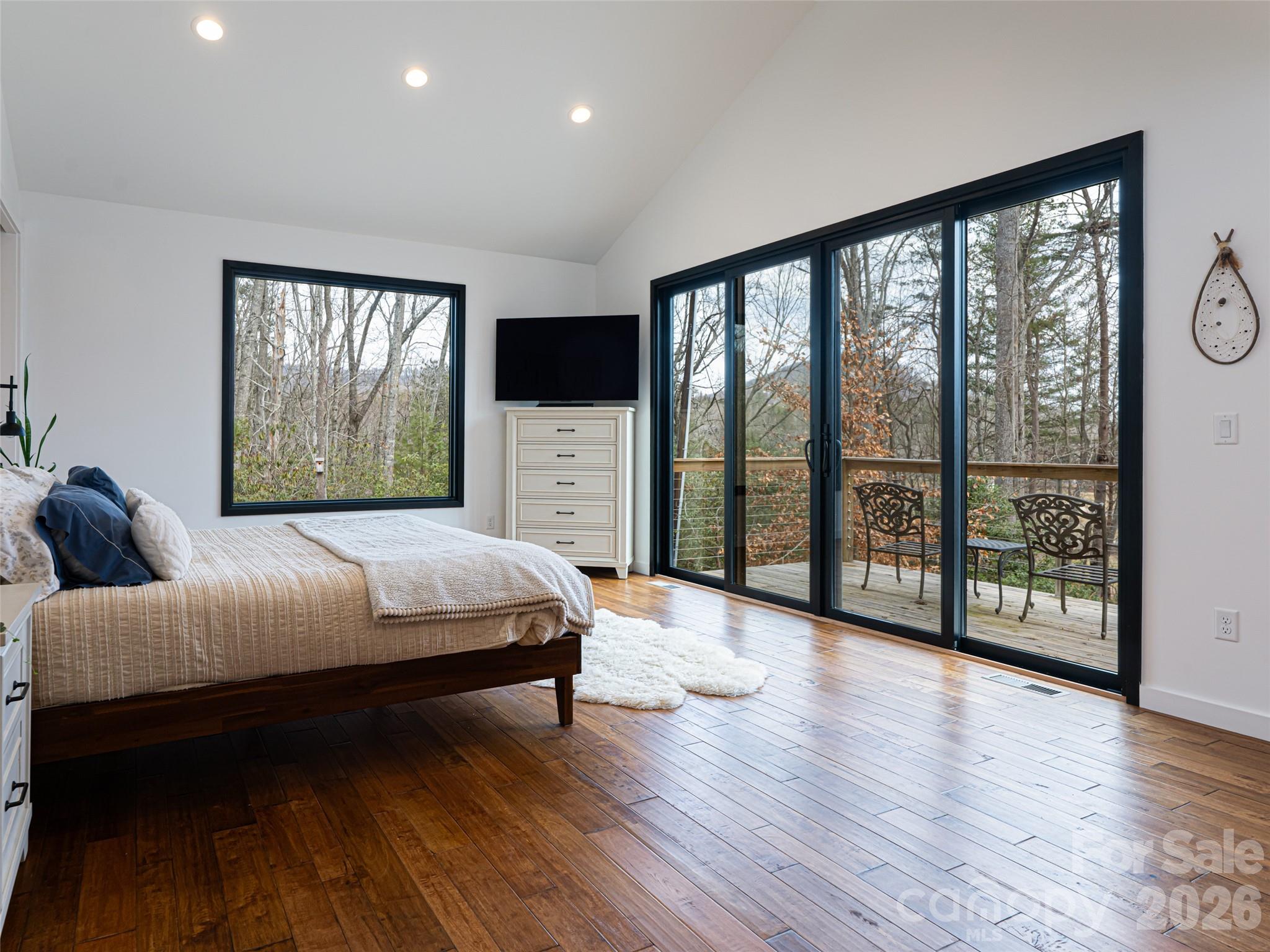 508 Avery Creek Road Arden, NC 28704 - Photo 13 of 47 a spacious bedroom with a large bed and a large window