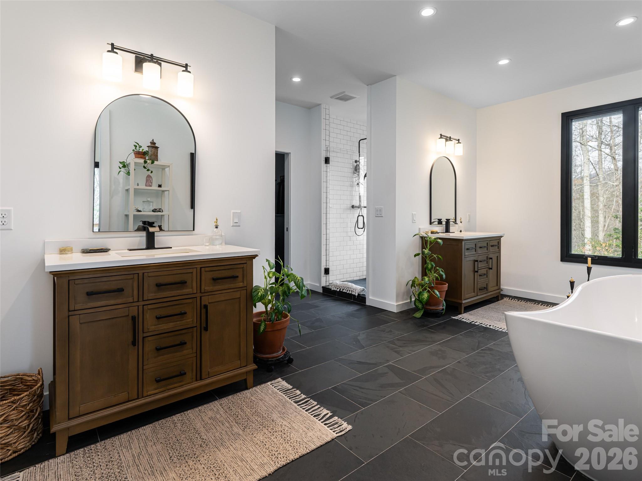 508 Avery Creek Road Arden, NC 28704 - Photo 16 of 47 a spacious bathroom with a double vanity sink and a mirror