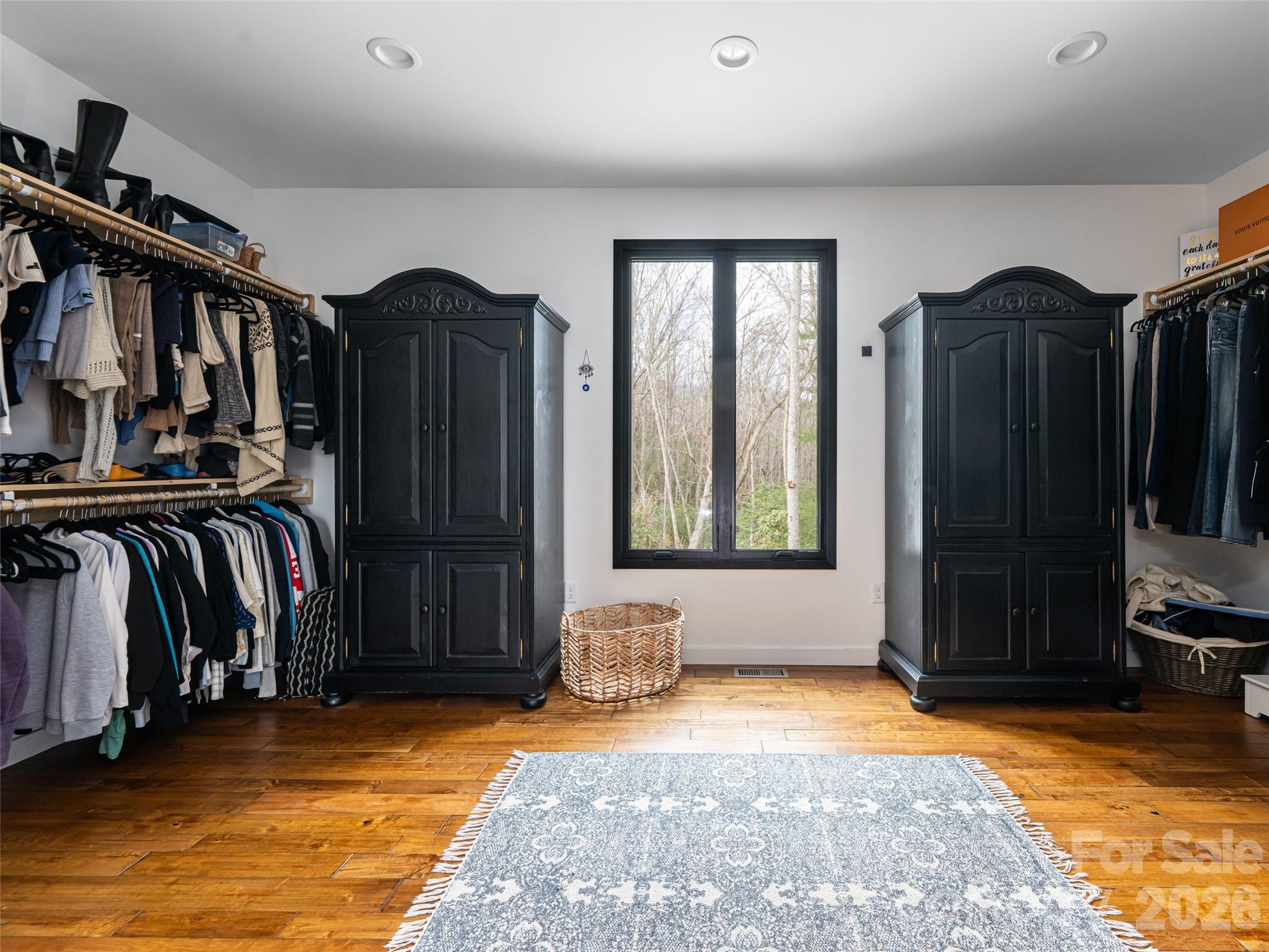 508 Avery Creek Road Arden, NC 28704 - Photo 17 of 47 a view of walk in closet with clothes and shoes