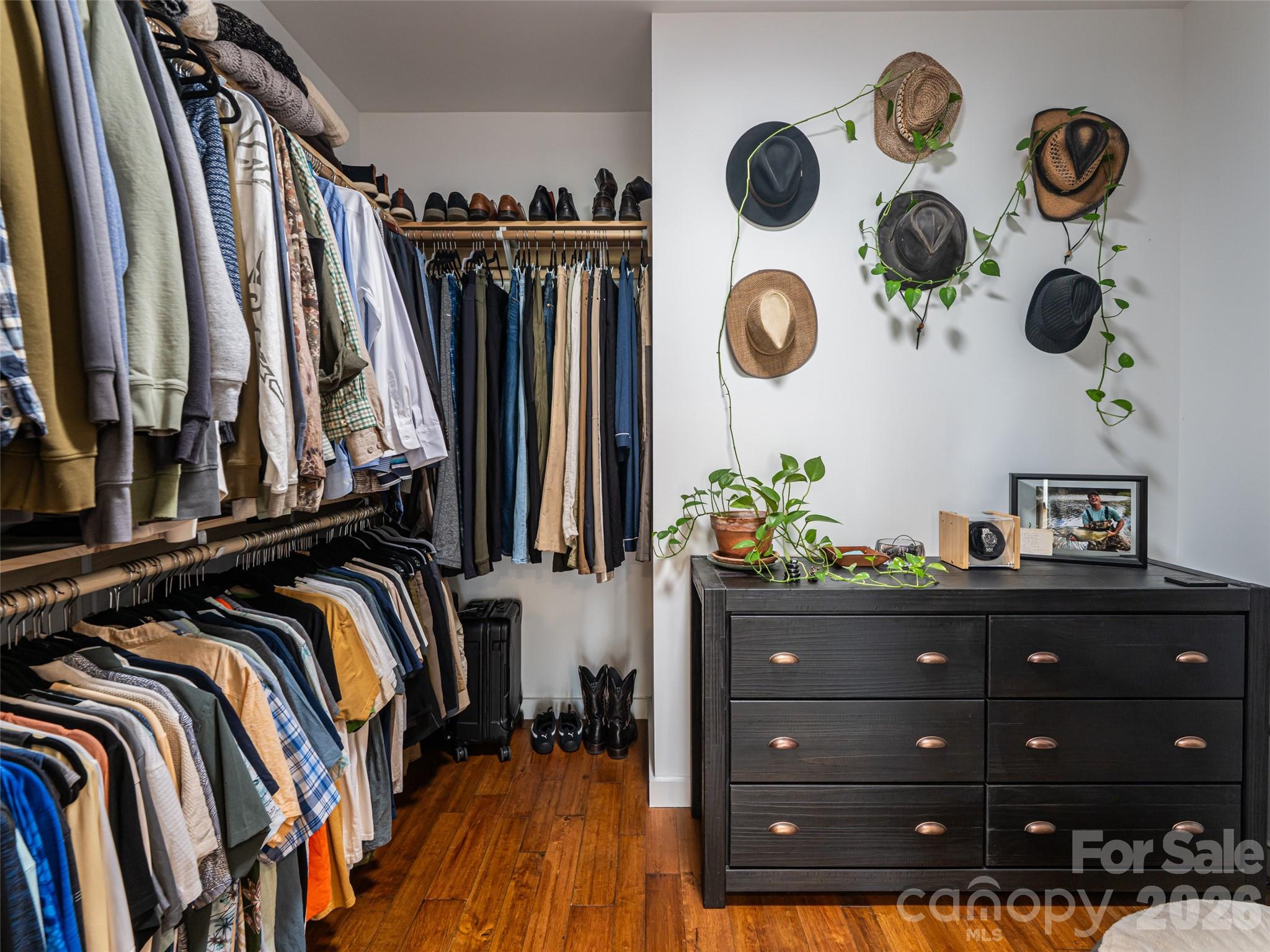 508 Avery Creek Road Arden, NC 28704 - Photo 18 of 47 a view of walk in closet with clothes and shoes