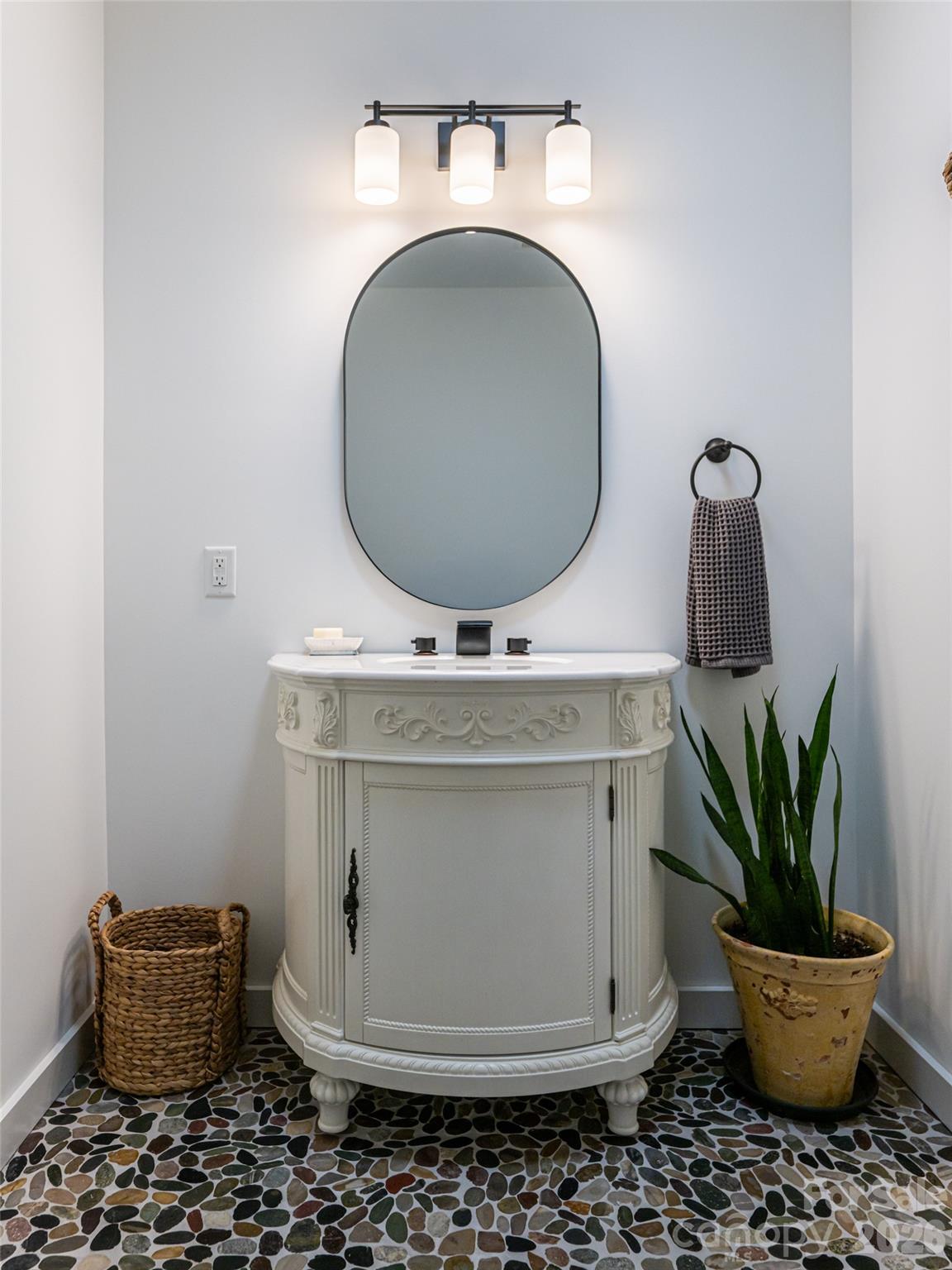 508 Avery Creek Road Arden, NC 28704 - Photo 23 of 47 a bathroom with a toilet a sink and a mirror