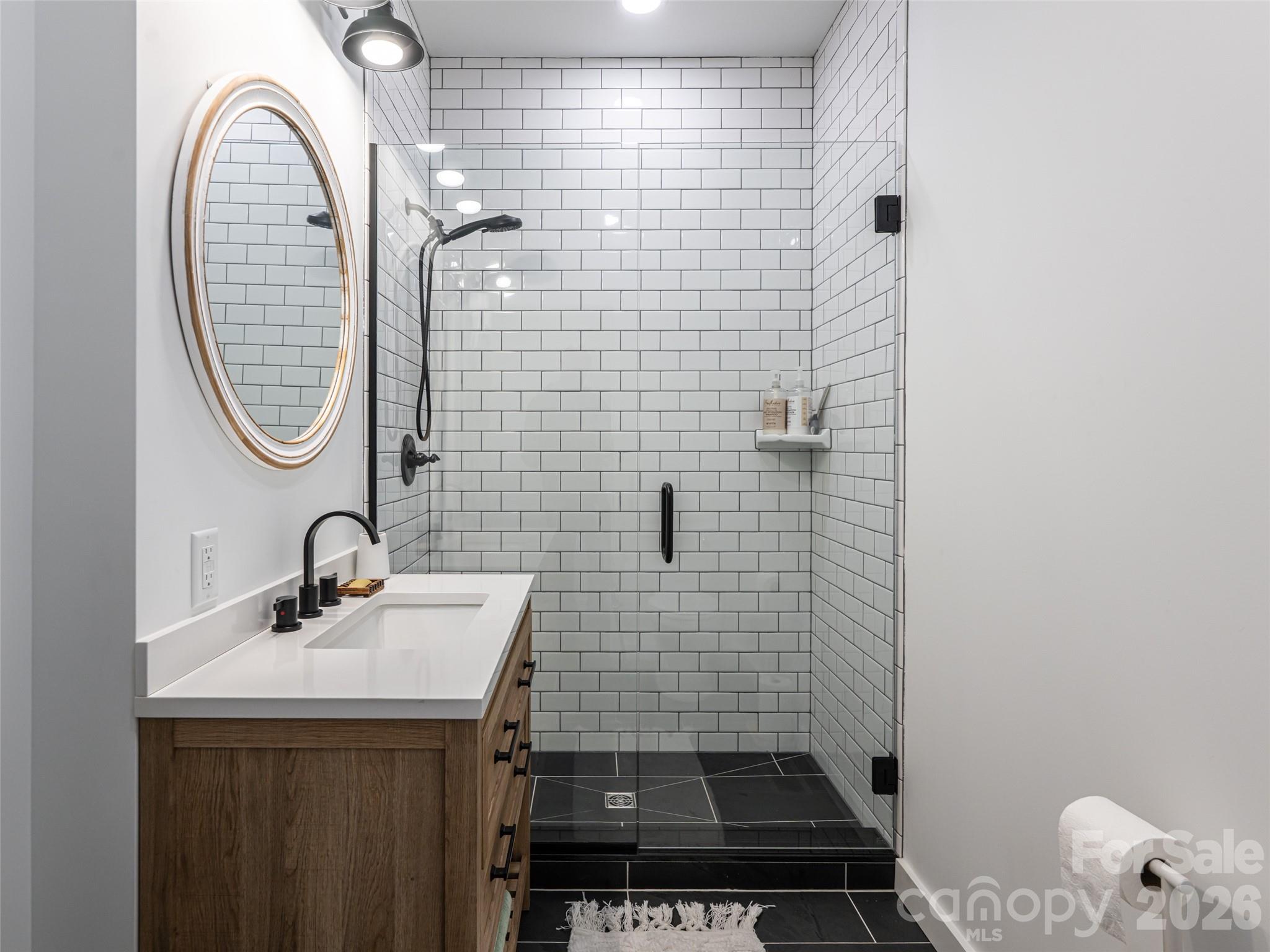 508 Avery Creek Road Arden, NC 28704 - Photo 28 of 47 a bathroom with a sink a toilet and a mirror
