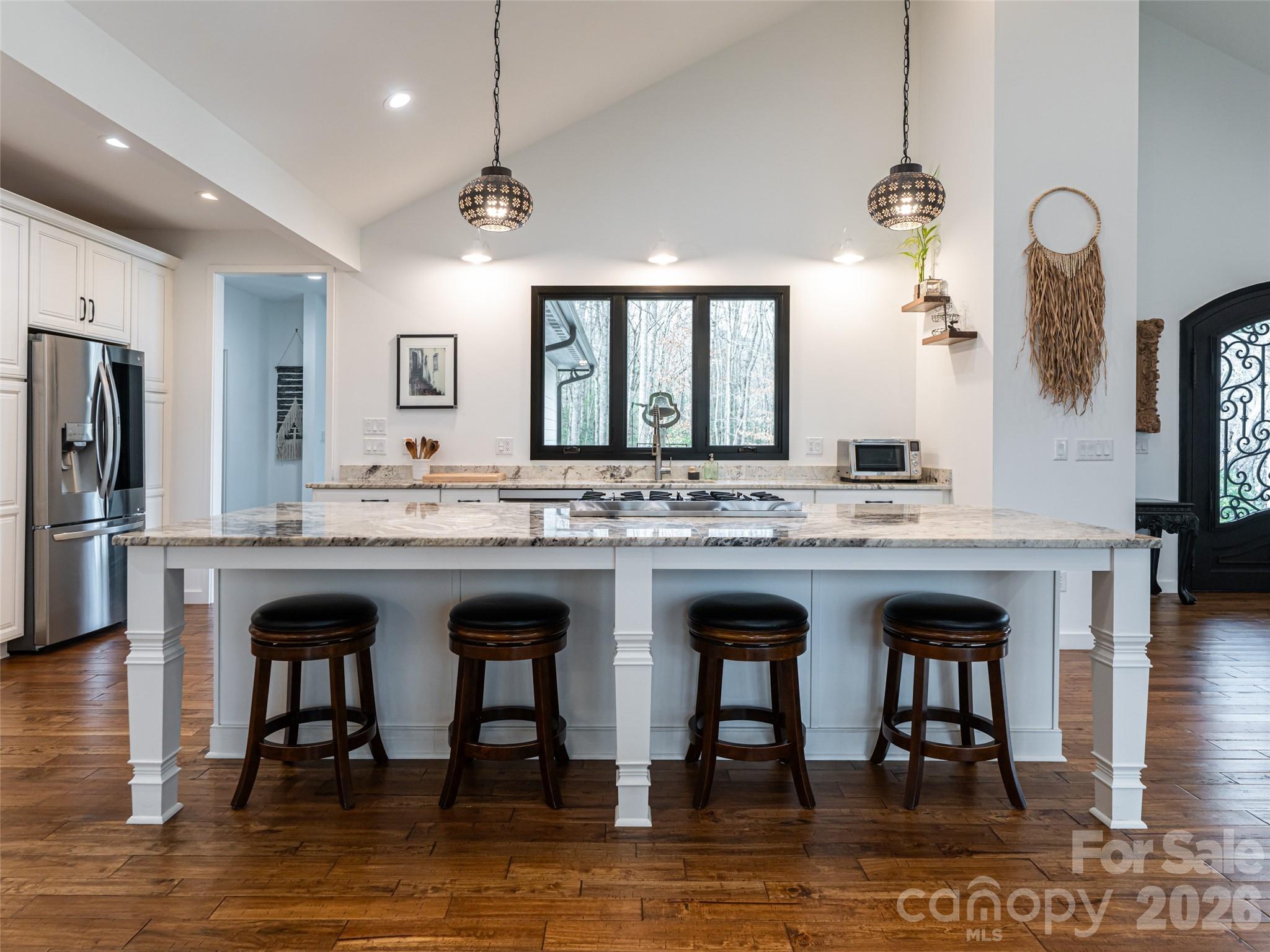 508 Avery Creek Road Arden, NC 28704 - Photo 4 of 47 a large white kitchen with granite countertop a stove a sink a window and stainless steel appliances