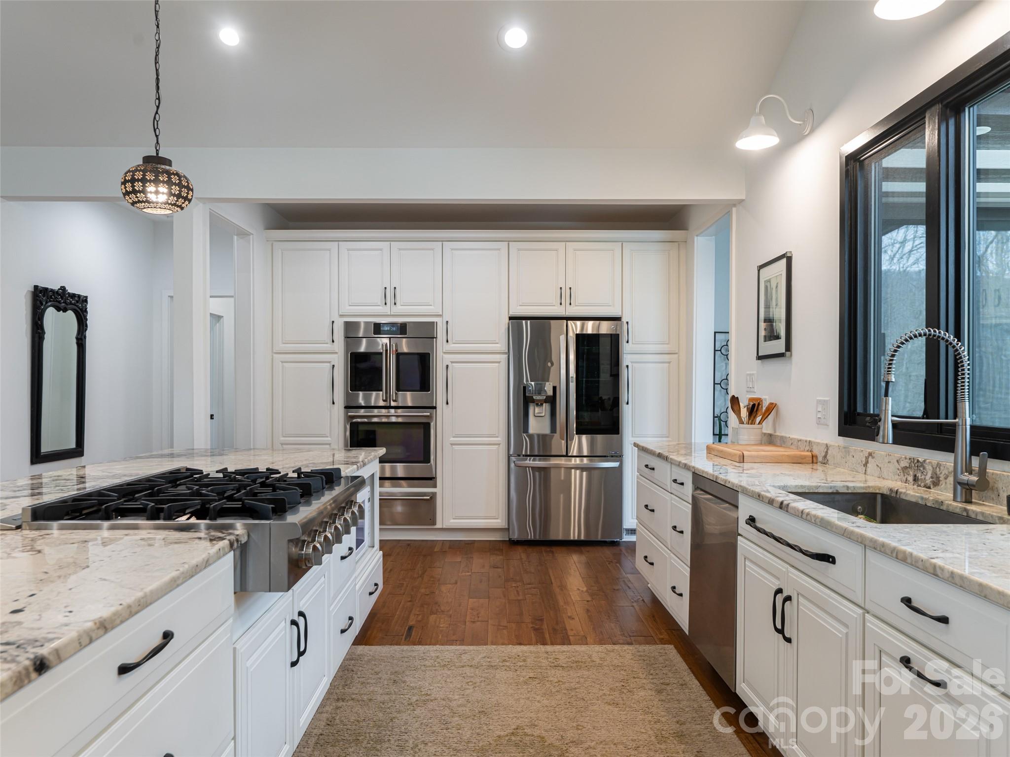 508 Avery Creek Road Arden, NC 28704 - Photo 5 of 47 a kitchen with stainless steel appliances granite countertop a stove refrigerator and cabinets