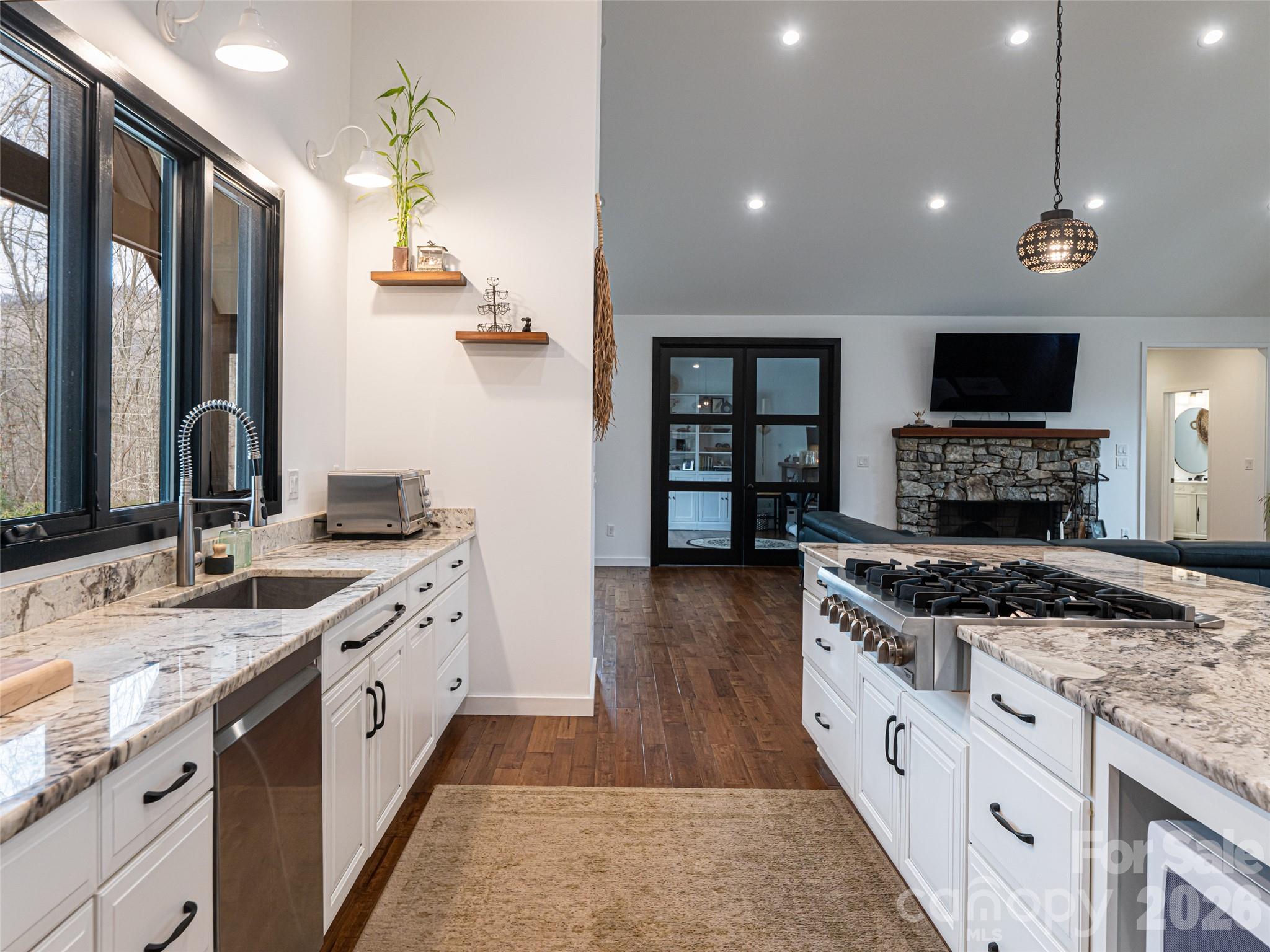 508 Avery Creek Road Arden, NC 28704 - Photo 7 of 47 a kitchen with stainless steel appliances granite countertop a stove top oven a sink a refrigerator and a oven