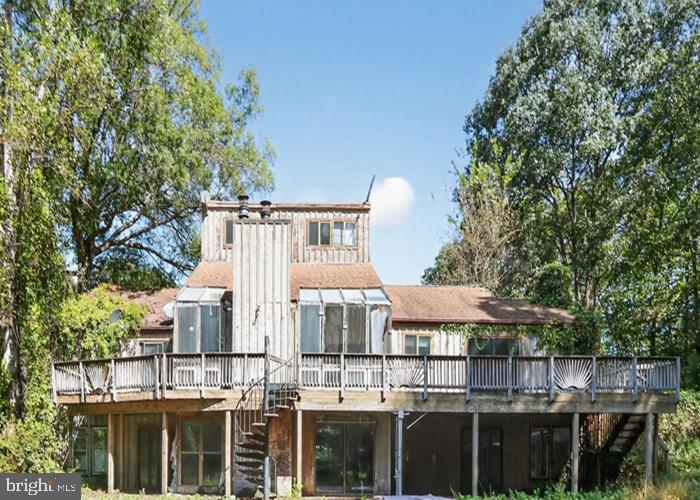 6320 Windpatterns Trail Fairfax Station, VA 22039 - Photo 1 of 21 a view of a multi story residential apartment building with a yard and entertaining space