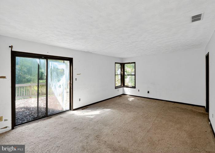 6320 Windpatterns Trail Fairfax Station, VA 22039 - Photo 12 of 21 a view of a big room with windows and chandelier fan