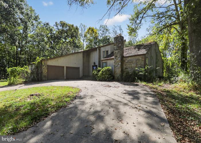 6320 Windpatterns Trail Fairfax Station, VA 22039 - Photo 3 of 21 a front view of a house with a yard and garage