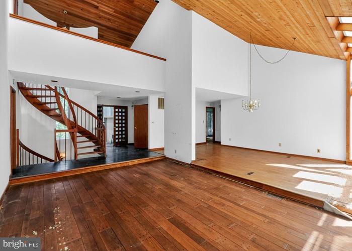6320 Windpatterns Trail Fairfax Station, VA 22039 - Photo 6 of 21 a view of an empty room with wooden floor and stairs