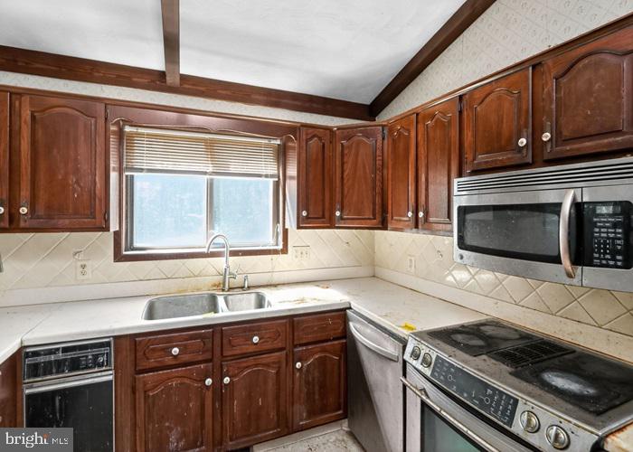 6320 Windpatterns Trail Fairfax Station, VA 22039 - Photo 8 of 21 a kitchen with granite countertop a sink cabinets and stainless steel appliances