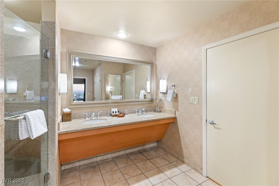 211 East Flamingo Road, Unit 610 Las Vegas, NV 89169 - Photo 16 of 42 Full bathroom featuring tile patterned flooring, a sink, a shower stall, and double vanity