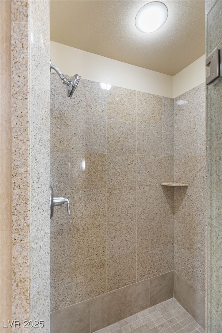 211 East Flamingo Road, Unit 610 Las Vegas, NV 89169 - Photo 20 of 42 Bathroom with a stall shower and a textured ceiling