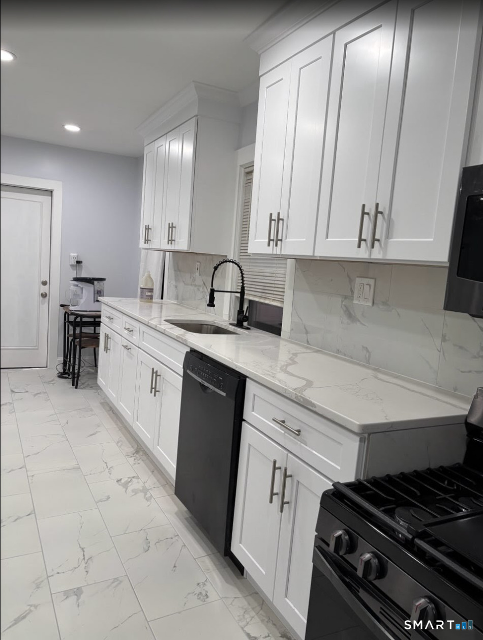 37 Biro Street Fairfield, CT 06825 - Photo 21 of 21 a kitchen with a stove sink and cabinets