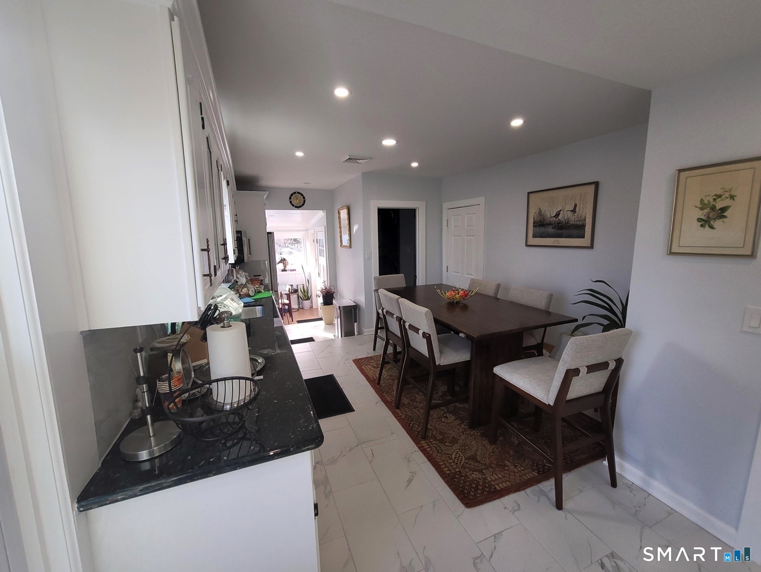 37 Biro Street Fairfield, CT 06825 - Photo 5 of 21 a living room with furniture and a dining table with wooden floor