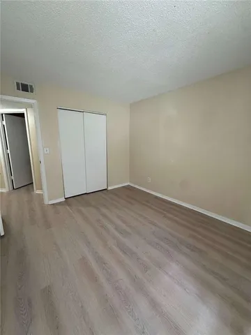 a view of an empty room and wooden floor