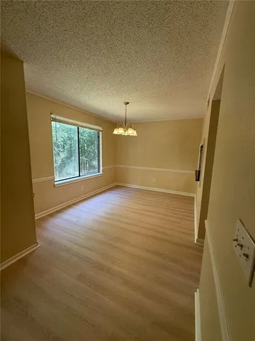 en empty room with windows and yard